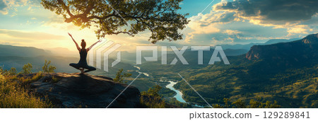 In a sunlit forest clearing, a woman holds a perfect yoga pose, her body aligned with the natural rhythm of the trees and the soft, dappled light, embodying calm and deep harmony with nature, banner 129289841