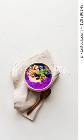 Delightful jar breakfasts showcase layers of creamy yogurt topped with fresh blueberries, granola, and a mint leaf, making for a nutritious start to the day 129290148