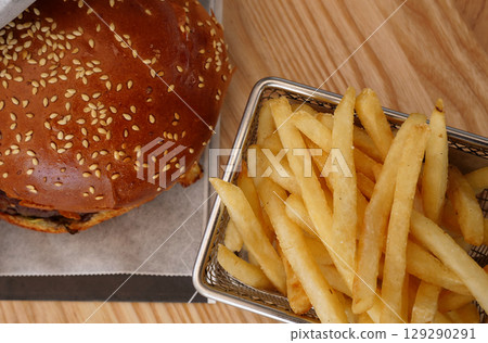 Flat Lay Detailed View Of Classic Burger And French Fries In Wire Basket Flat Lay Detailed View Of Classic Burger And French Fries In Wire Basket 129290291