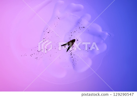 Beautiful texture of gel-like serum with a leaf on a purple background. Beautiful texture of gel-like serum with a leaf on a purple background. 129290547