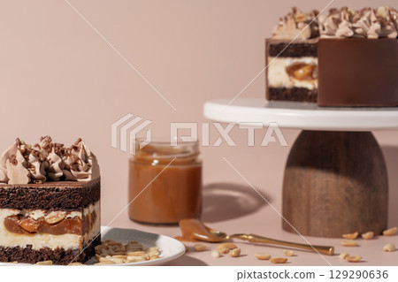 Chocolate sponge bento cake layered with caramel and nuts, topped with creamy frosting, presented on a wooden pedestal, showcasing a delightful dessert and pastry menu concept 129290636