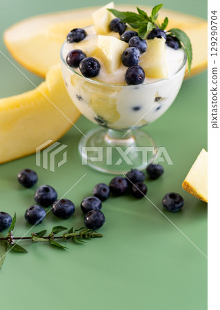 Elegant dessert in a glass yogurt melon blueberries and mint Elegant dessert in a glass yogurt melon blueberries and mint 129290704
