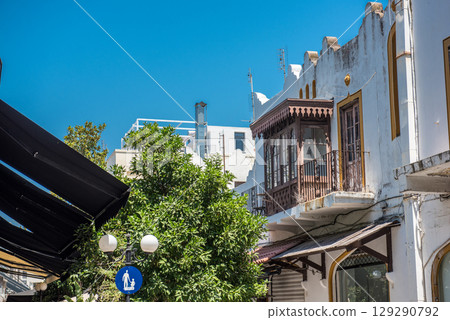 Rhodes.Greece. Street in Rhodes Old Town, flanked by traditional buildings under a vibrant blue. 129290792
