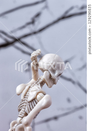 Skeleton figurine touch back of head. Headache migraine, neck pain, Cervical syndrome, traumatic concept 129290835