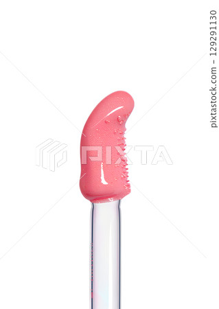 Close-up of lip gloss applicator with pink shimmer, glossy makeup product isolated on transparent background Close-up of lip gloss applicator with pink shimmer, glossy makeup product isolated on transparent background 129291130