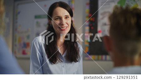 Female Teacher Teacher Praising Student for Excellent Academic Performance to His Mother 129291351