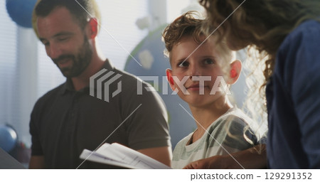 Mother and Father Looking at School Test Results of Their Son, Happy About Excellent Academic Performance Mother and Father Looking at School Test Results of Their Son, Happy About Excellent Academic Performance 129291352