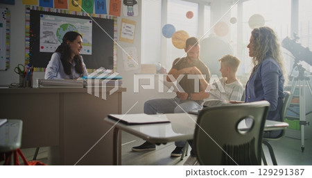 Mother and Father Looking at School Test Results of Their Son, Happy About Excellent Academic Performance 129291387