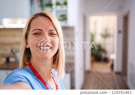 Smiling female doctor taking selfie at hospital 129291461