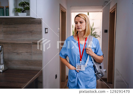 Sad female doctor coming back home after work Sad female doctor coming back home after work 129291470