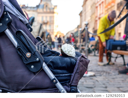 Baby carriage with bouquet of white flowers in Lviv, Ukraine Baby carriage with bouquet of white flowers in Lviv, Ukraine 129292013