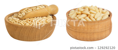 Shelled European pine nuts in wooden bowl and scoop isolated on white background with full depth of field Shelled European pine nuts in wooden bowl and scoop isolated on white background with full depth of field 129292120