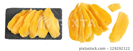 dried mango on a black stone board isolated on white background. Top view. Flat lay dried mango on a black stone board isolated on white background. Top view. Flat lay 129292122