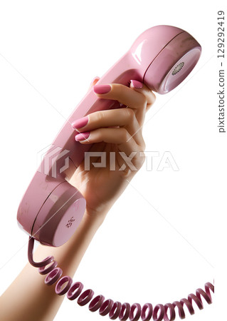 Woman's manicured hand holding pastel pink phone receiver, feminine vintage telecom concept isolated Woman's manicured hand holding pastel pink phone receiver, feminine vintage telecom concept isolated 129292419