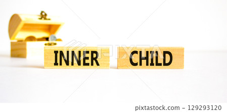 Inner child symbol. Concept words Inner child on beautiful wooden block. Beautiful white table white background. Wooden chest with coins. Psychological, motivational inner child concept. Copy space. Inner child symbol. Concept words Inner child on beautiful wooden block. Beautiful white table white background. Wooden chest with coins. Psychological, motivational inner child concept. Copy space. 129293120