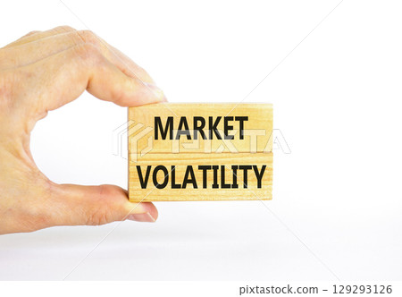 Market volatility symbol. Concept words Market volatility on beautiful wooden blocks. Beautiful white table white background. Businessman hand. Business market volatility concept. Copy space. Market volatility symbol. Concept words Market volatility on beautiful wooden blocks. Beautiful white table white background. Businessman hand. Business market volatility concept. Copy space. 129293126