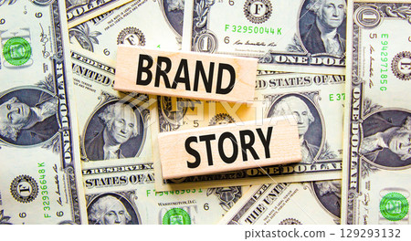 Brand story branding symbol. Concept words Brand story on beautiful wooden blocks. Dollar bills. Beautiful background from dollar bills. Business brand story branding concept. Copy space. 129293132