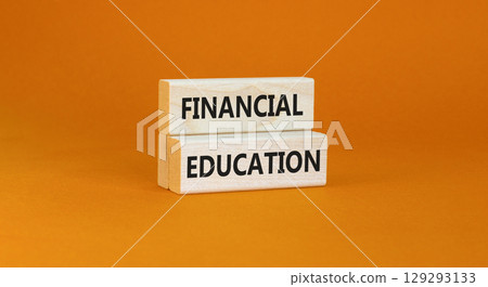 Financial education symbol. Concept words Financial education on beautiful wooden block. Beautiful orange paper background. Business Financial education concept. Copy space. Financial education symbol. Concept words Financial education on beautiful wooden block. Beautiful orange paper background. Business Financial education concept. Copy space. 129293133