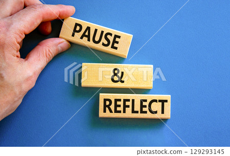 Pause and reflect symbol. Concept words Pause and reflect on beautiful block. Businessman's hand. Beautiful blue background. Business motivational lifestyle pause and reflect concept. Copy space. 129293145
