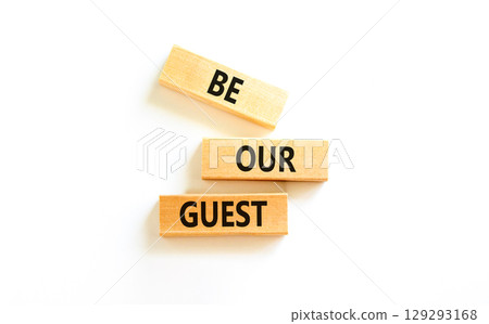 Be our guest symbol. Concept words Be our guest on beautiful wooden block. Beautiful white table white background. Business and be our guest concept. Copy space. 129293168