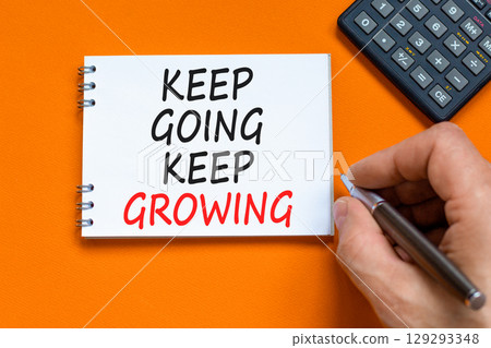 Keep going and growing symbol. Concept words phrase Keep going keep growing on beautiful white note. Calculator. Beautiful orange background. Business Keep going and growing concept. Copy space. 129293348