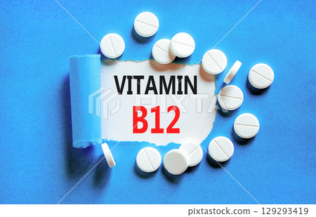 Vitamin B12 symbol. Concept words Vitamin B12 on beautiful white paper. White pills tablets. Beautiful blue background. Medical healthy lifestyle Vitamin B12 concept. Vitamin B12 symbol. Concept words Vitamin B12 on beautiful white paper. White pills tablets. Beautiful blue background. Medical healthy lifestyle Vitamin B12 concept. 129293419