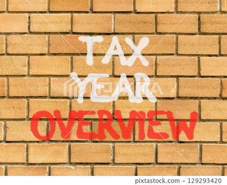 Tax year overview symbol. Concept words Tax year overview on beautiful brown brick wall. Beautiful brown brick wall background. Business tax year overview concept. Copy space. 129293420