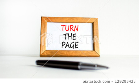 Turn the page symbol. Concept words Turn the page on beautiful wooden picture frame. Black pen. Beautiful white background. Business motivational lifestyle turn the page concept. Copy space. 129293423