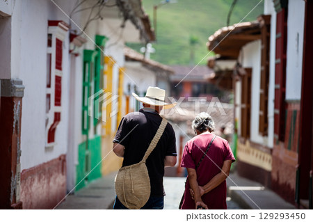Local people walking at the beautiful streets of the colonial town of Concepcion in Antioquia, Colombia. 129293450