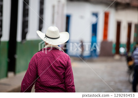 Local man wearing a traditional hat walking at the beautiful streets of the colonial town of Concepcion in Antioquia, Colombia. 129293453