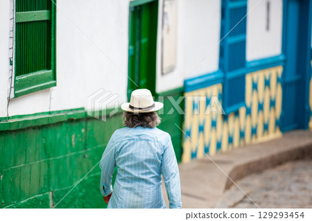 Local man wearing a traditional hat walking at the beautiful streets of the colonial town of Concepcion in Antioquia, Colombia. 129293454