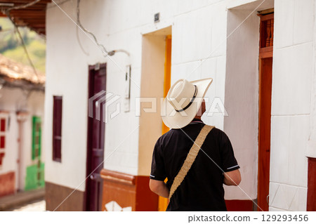 Local man wearing a traditional hat walking at the beautiful streets of the colonial town of Concepcion in Antioquia, Colombia. 129293456