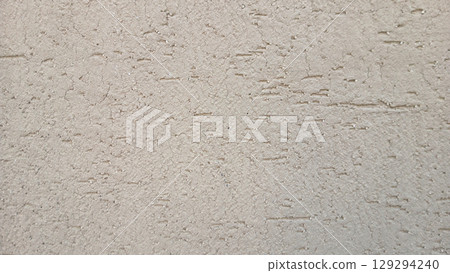 Close-Up of Rough Textured Plastered Wall in Neutral Beige Tone 129294240