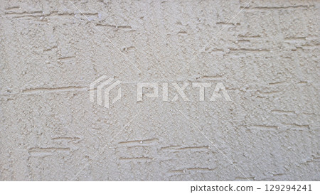 Close-Up of Rough Textured Plastered Wall in Neutral Beige Tone 129294241