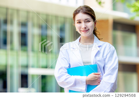 Female student in white coat 129294508