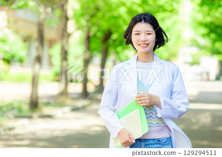 Female student in white coat 129294511