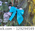 Part of a Christmas tree with a blue bow. The concept of Christmas and New Year 129294549