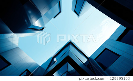 Bottom-up view of a modern building made of glass and concrete 129295193