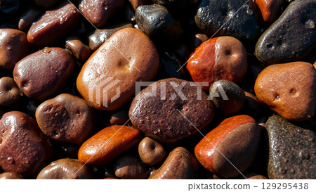 Wet pebbles on the beach 129295438
