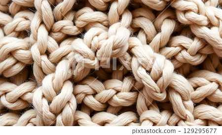 Texture of beige wool knitted fabric 129295677