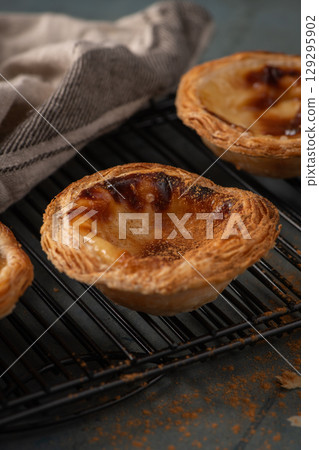 Golden, flaky Portuguese custard tarts 129295902
