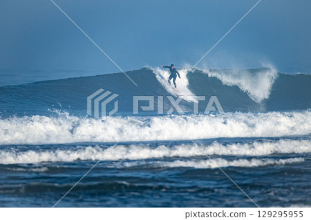 Surfer riding waves in Furadouro Beach 129295955