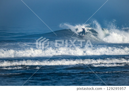 Surfer riding waves in Furadouro Beach Surfer riding waves in Furadouro Beach 129295957