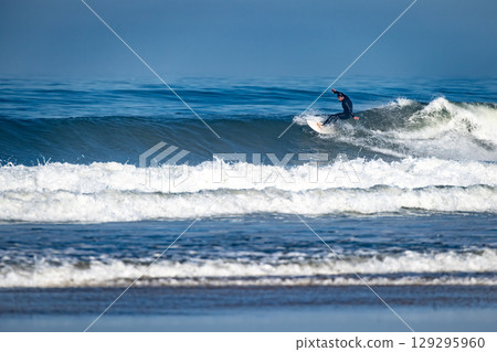 Surfer riding waves in Furadouro Beach 129295960