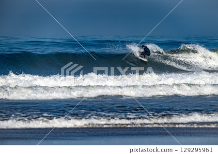 Surfer riding waves in Furadouro Beach 129295961