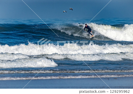 Surfer riding waves in Furadouro Beach Surfer riding waves in Furadouro Beach 129295962