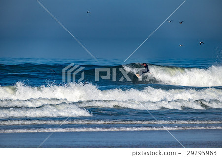 Surfer riding waves in Furadouro Beach Surfer riding waves in Furadouro Beach 129295963