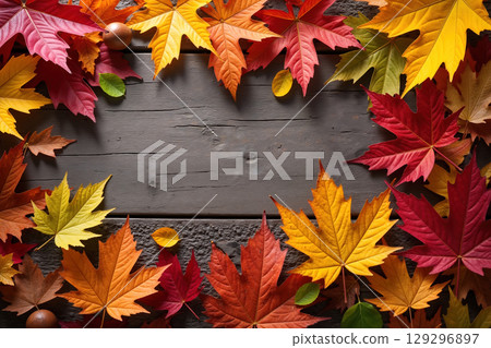Colorful leaves on a wooden background. 129296897