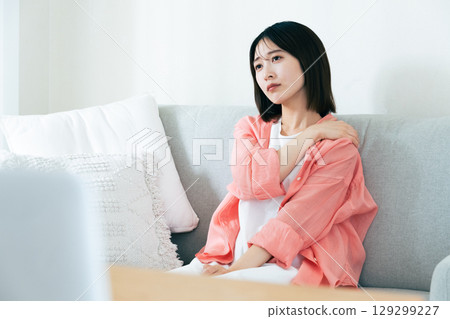 Young woman thinking in the living room Young woman thinking in the living room 129299227