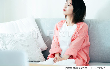 Young woman thinking in the living room Young woman thinking in the living room 129299240